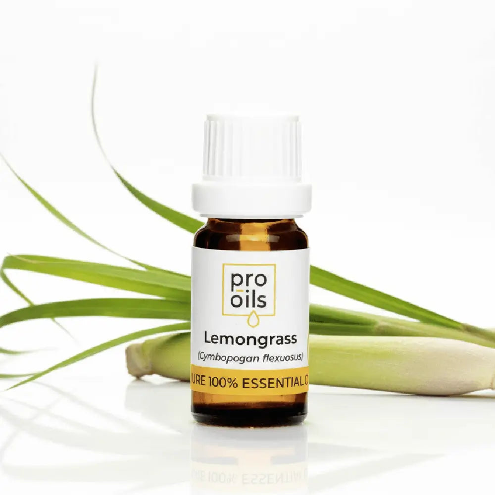 Bottle of Pro Oils Lemongrass essential oil with lemongrass leaves on a white background