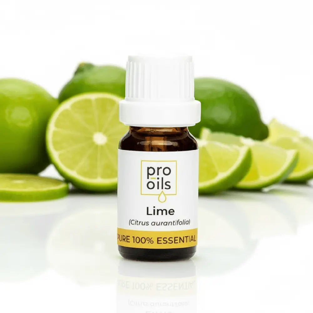 Bottle of Pro Oils Lime essential oil with limes in the background