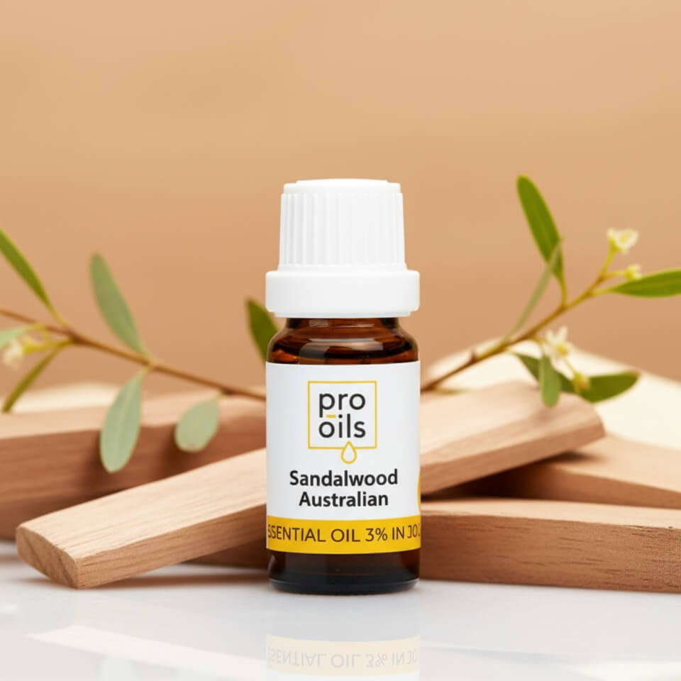 Bottle of Pro Oils Sandalwood Australian essential oil with wooden planks and leaves on a beige background