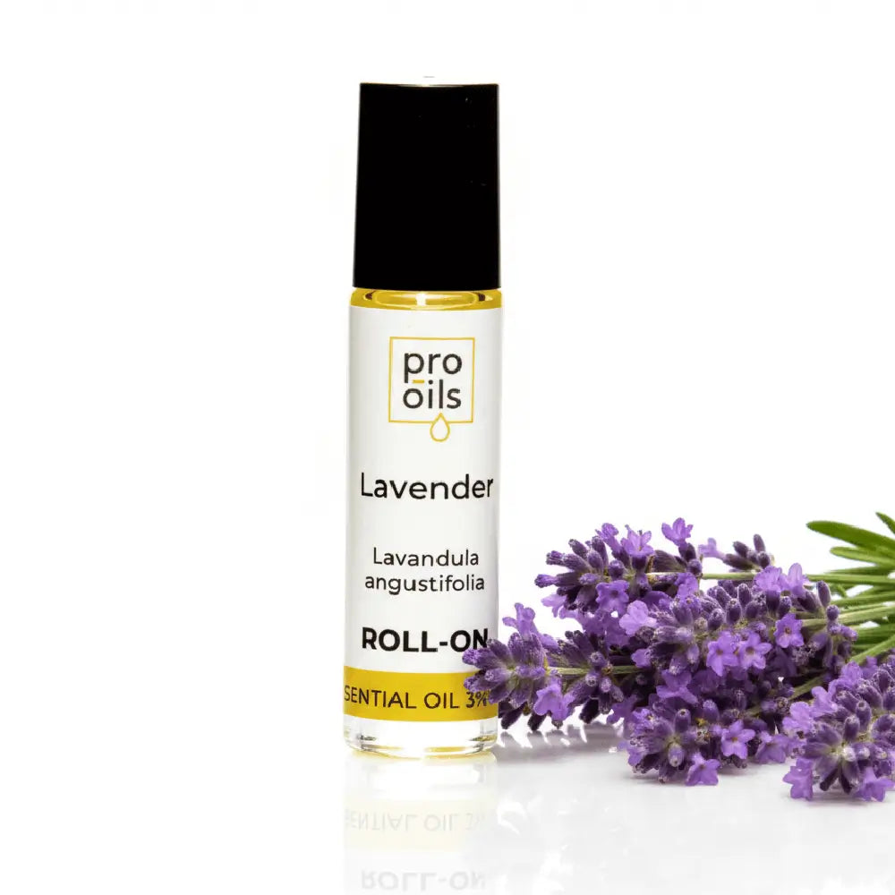 Lavender roll-on essential oil bottle with lavender flowers on a white background