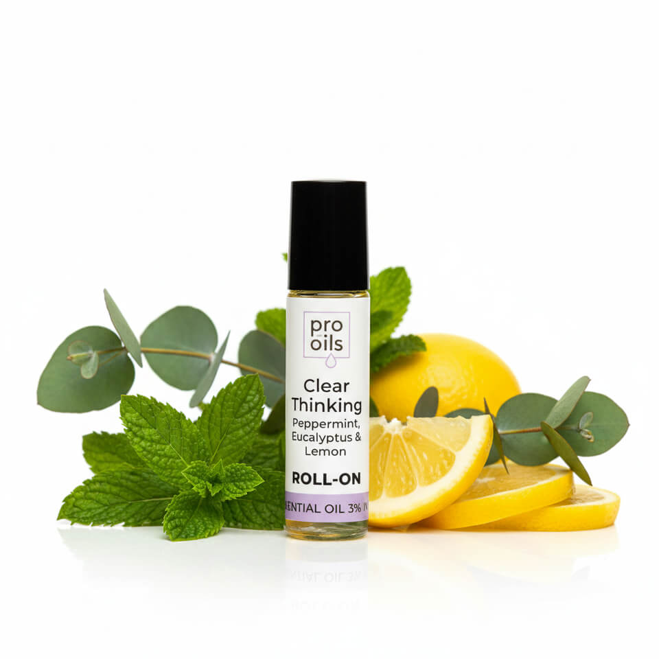Roll-on bottle of pro oils Clear Thinking with lemons and mint leaves on a white background