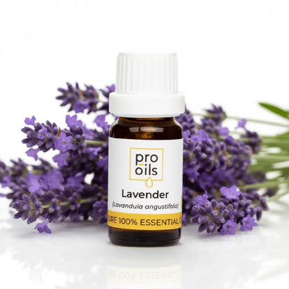 Bottle of Pro Oils lavender essential oil with lavender flowers on a white background