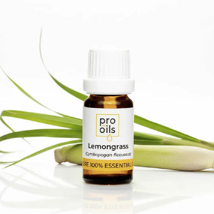 Bottle of Pro Oils Lemongrass essential oil with lemongrass leaves on a white background