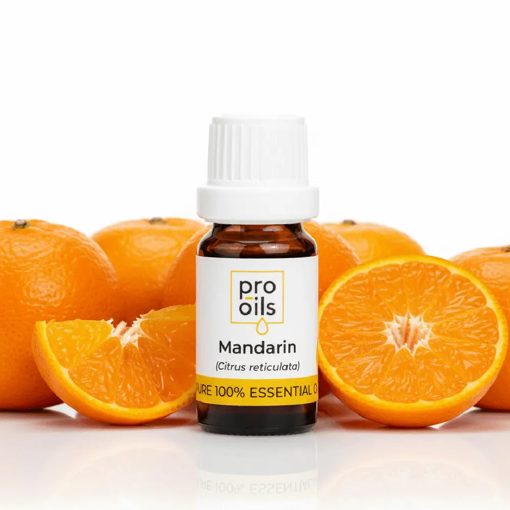 Bottle of pro oils Mandarin essential oil with mandarin oranges on a white background