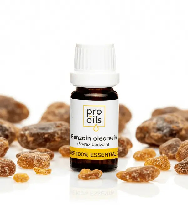 Bottle of Pro Oils benzoin oleoresin surrounded by benzoin resin on a white background