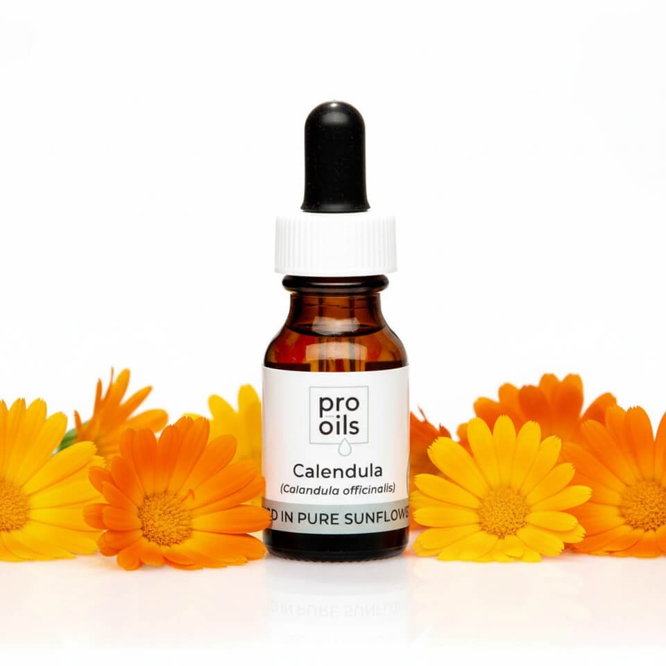Bottle of Pro Oils Calendula oil with calendula flowers on a white background