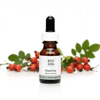 Bottle of Pro Oils Rosehip oil with rosehips on a white background