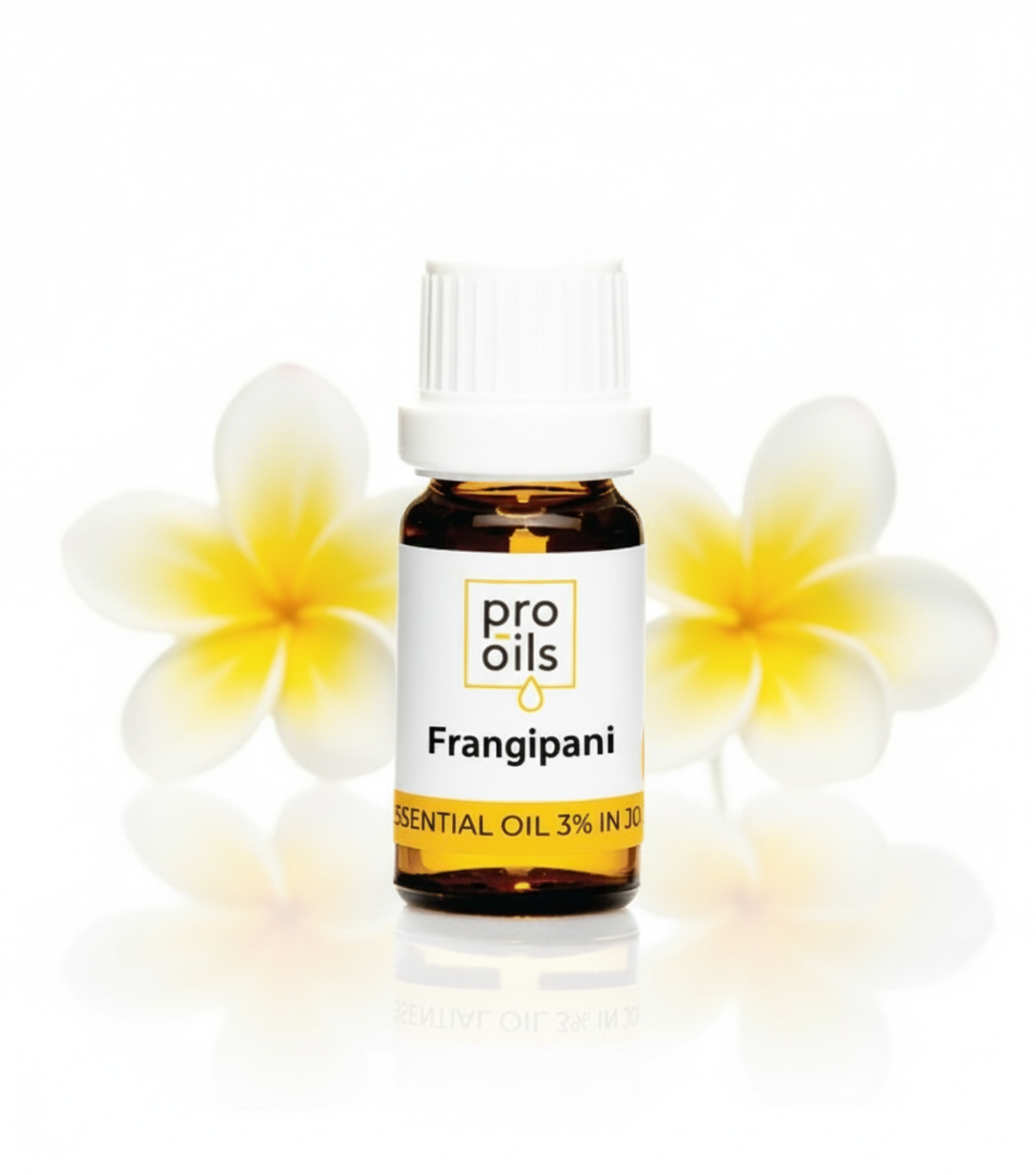 Bottle of Pro Oils Frangipani essential oil with two flowers on a white background