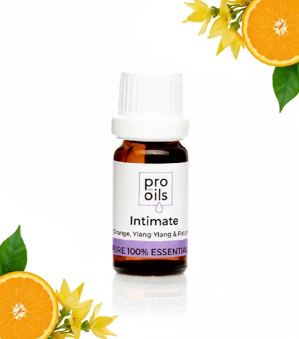Bottle of pro oils Intimate with oranges and flowers on a white background
