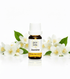 Bottle of Pro Oils Jasmine essential oil with jasmine flowers on a white background