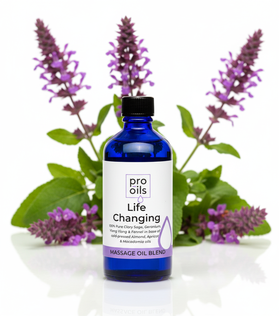 Blue bottle of Pro Oils Life Changing Massage Oil Blend with lavender flowers in the background