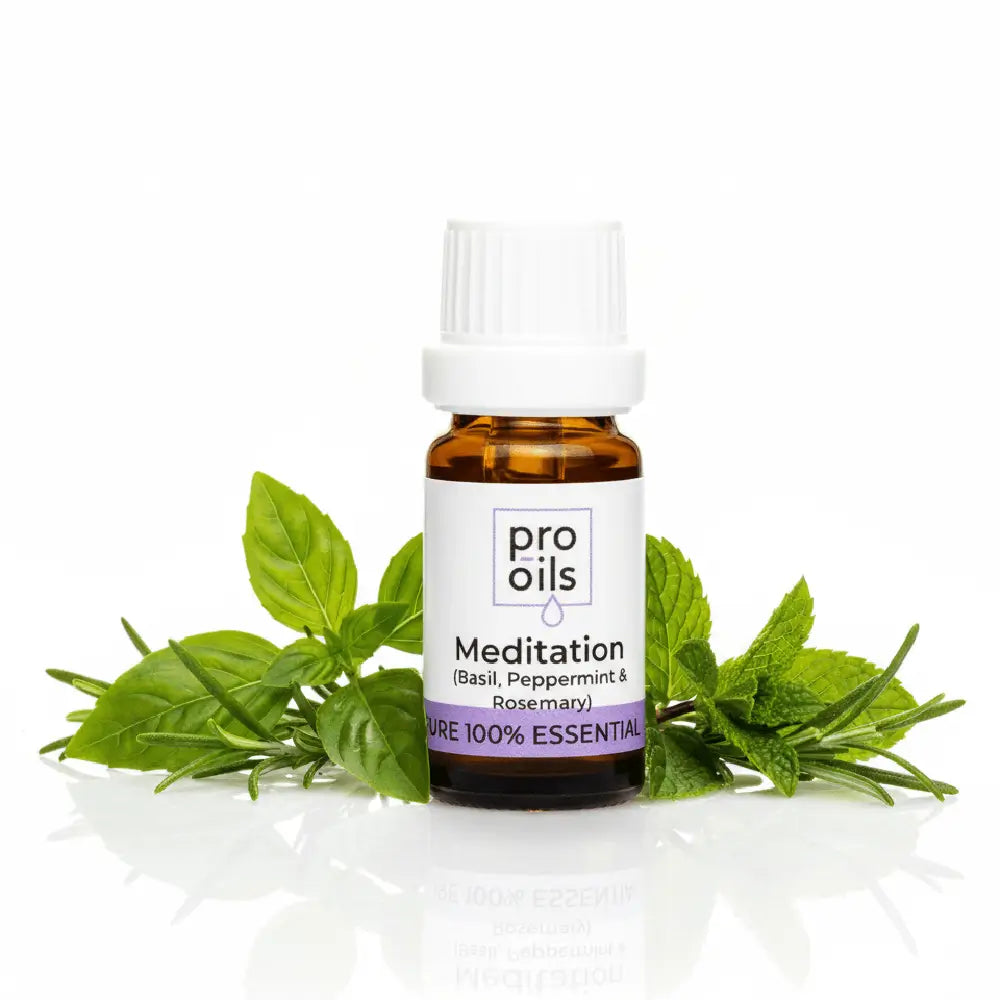 Bottle of pro oils Meditation essential oil blend with basil and peppermint leaves on a white background