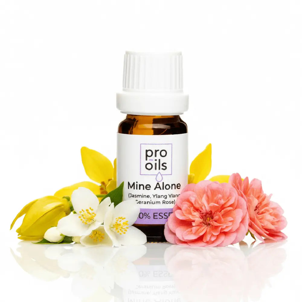 Pro Oils Mine Alone essential oil bottle with flowers on a white background