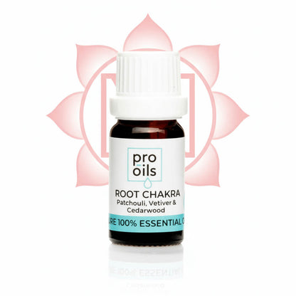 Bottle of pro oils Root Chakra essential oil blend with a pink lotus flower in the background