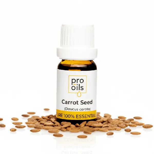 Bottle of Pro Oils Carrot Seed essential oil with seeds on a white background