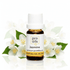 Bottle of Pro Oils Jasmine essential oil with jasmine flowers on a white background