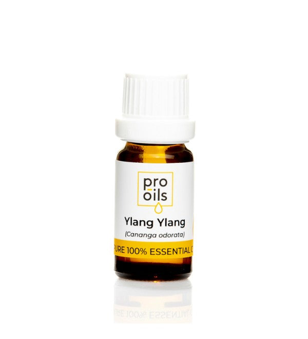 Ylang Ylang essential oil bottle surrounded by fresh ylang ylang flowers, highlighting its aromatic and therapeutic properties